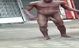 Caught Completely naked black tramp shows off his huge cock on the street