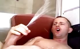 Horny stud watching porn and shooting his load on his face