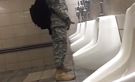 Spying a military guy stroking his cock in a toilet