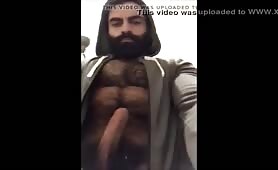 Hairy bearded bear strokes his cock outdoor
