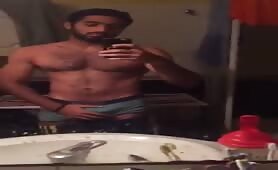 Cute fit arab guy strokes his cock in front of the mirror