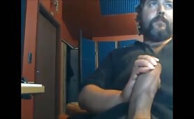 Huge bearded bear stroking his huge fat cock in front of the computer