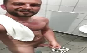 Stud wanking in a public toilet with a happy face